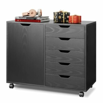 Black storage cabinet with books, headphones, and gifts on top