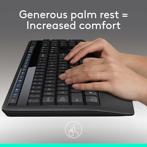 Hands typing on a keyboard with a generous palm rest for increased comfort.