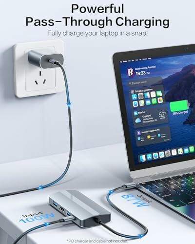 Laptop charging with pass-through hub showing power status.