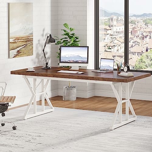 Modern office desk with computer, laptop, and decor