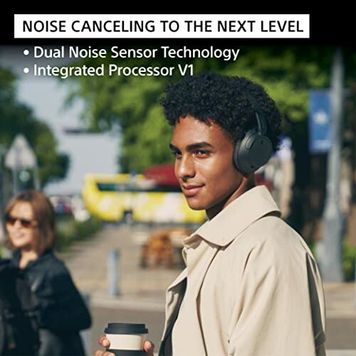 Person wearing noise-cancelling headphones outdoors.