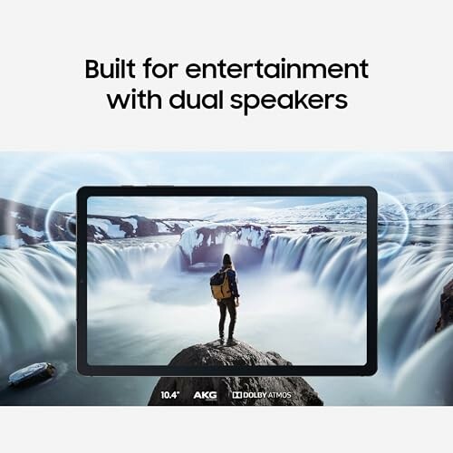 Tablet with dual speakers featuring a person standing by a waterfall
