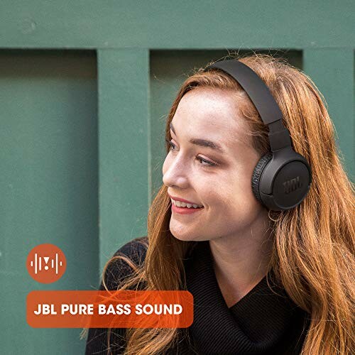 Woman wearing JBL headphones outdoors